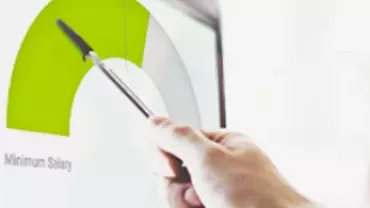 Persona señalando gráfico en pantalla con bolígrafo.